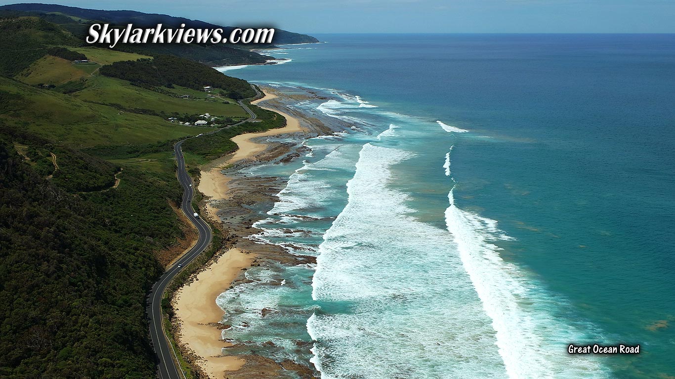 aerial view of road along spectacular coastline