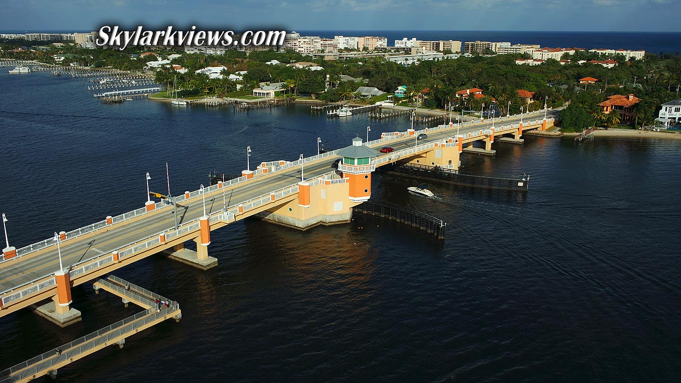 close aerial view of a orange bridge, waterfront houses